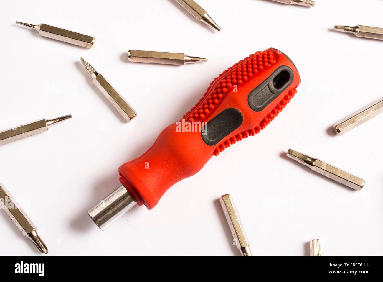 red screwdriver, white background and bits, spare parts Stock Photo Alamy