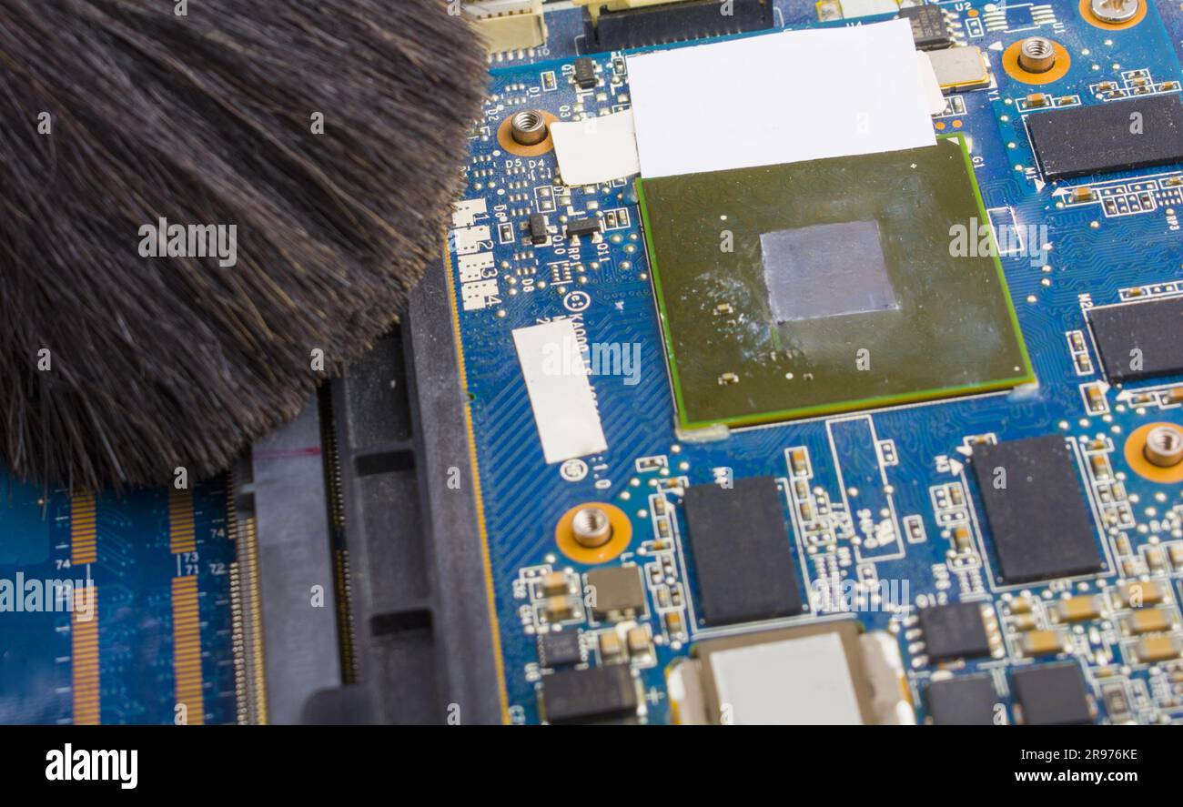Picture of Cleaning the motherboard from dust and debris with a brush Stock Photo ...