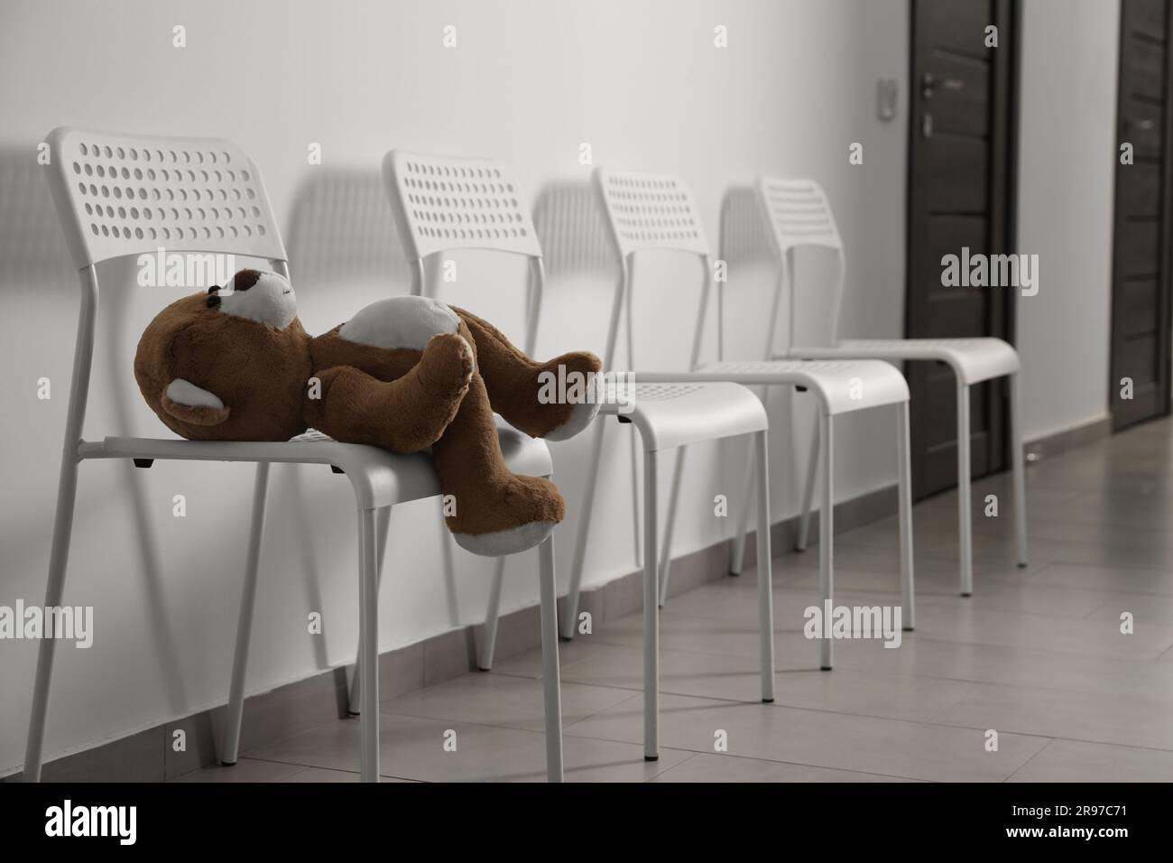 Cute teddy bear left on chair indoors. Space for text Stock Photo - Alamy