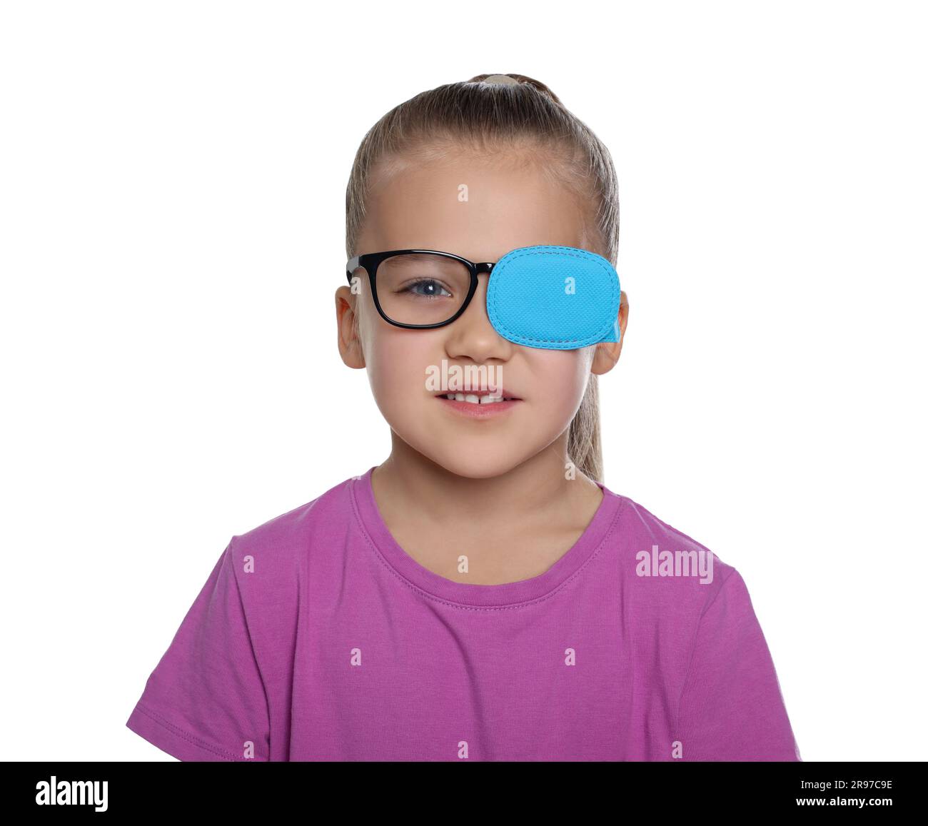 Girl with eye patch on glasses against white background. Strabismus