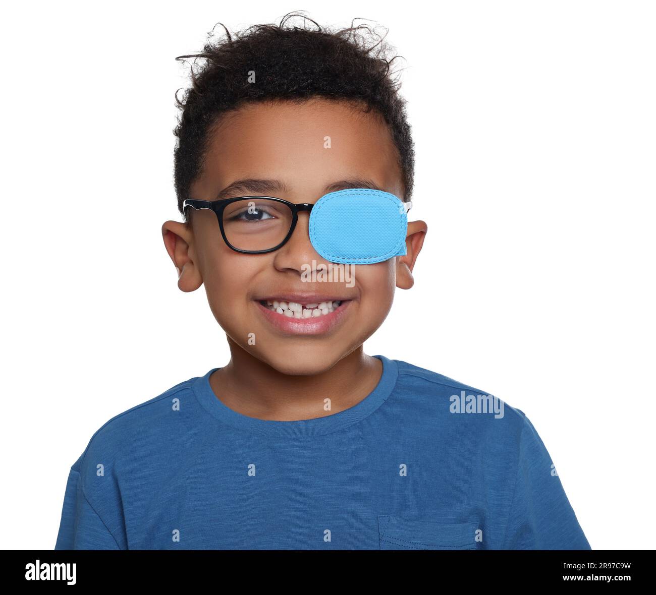 African American boy with eye patch on glasses against white background. Strabismus treatment Stock Photo