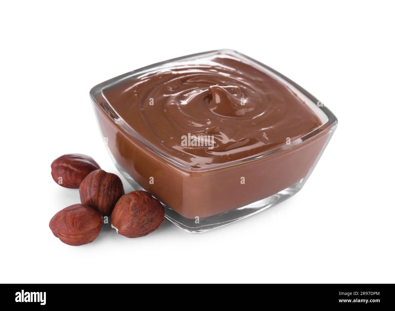 Bowl with delicious chocolate paste and hazelnuts on white background Stock Photo