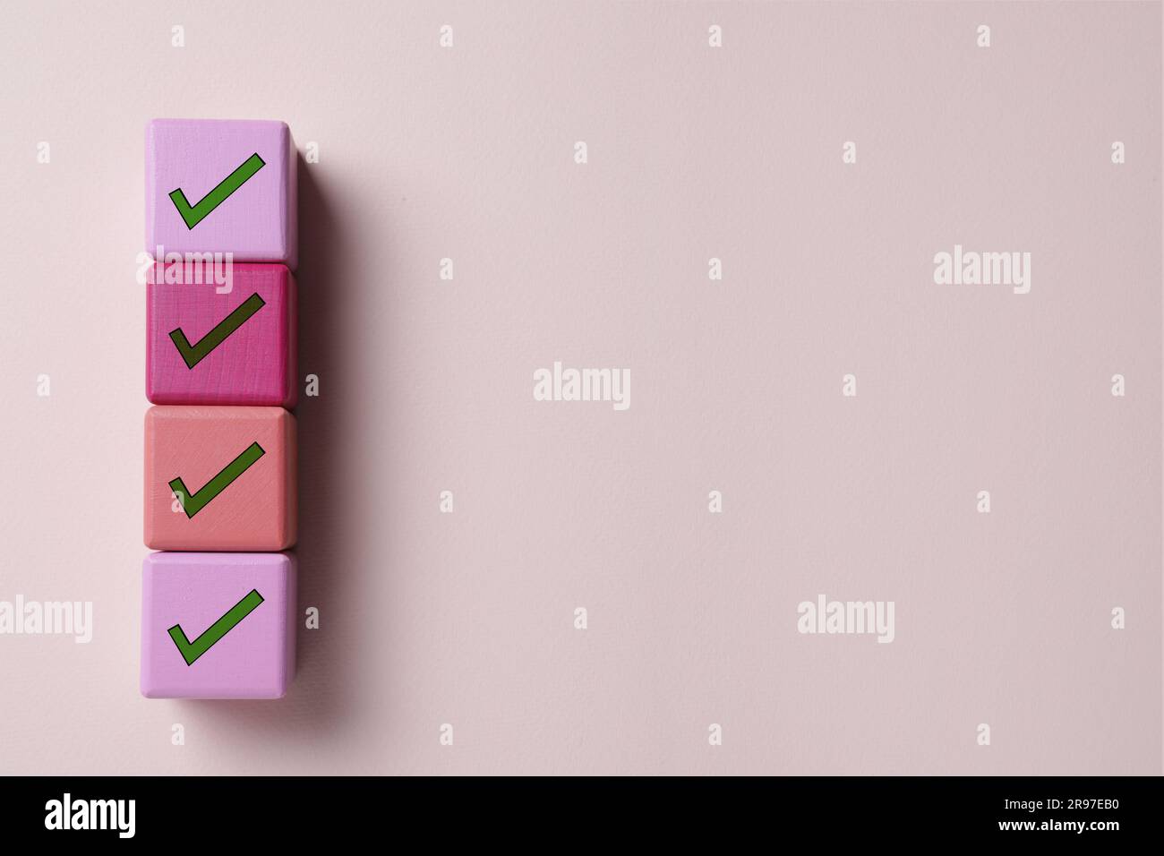 Check Mark Cube Cubes with check marks on beige background, top view. Space for text ...