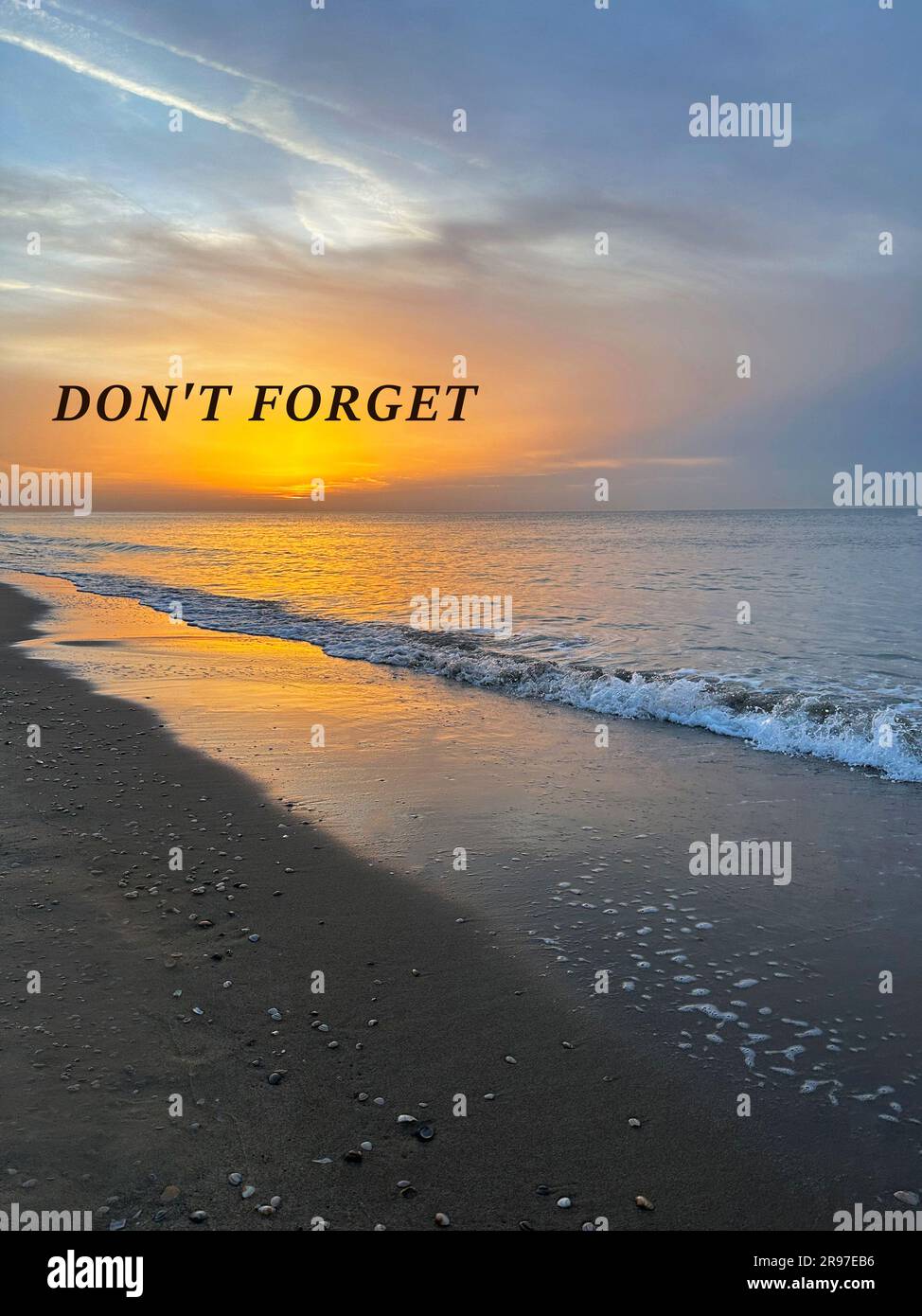 Don't forget, affirmation. Sea waves rolling onto sandy beach at sunrise Stock Photo
