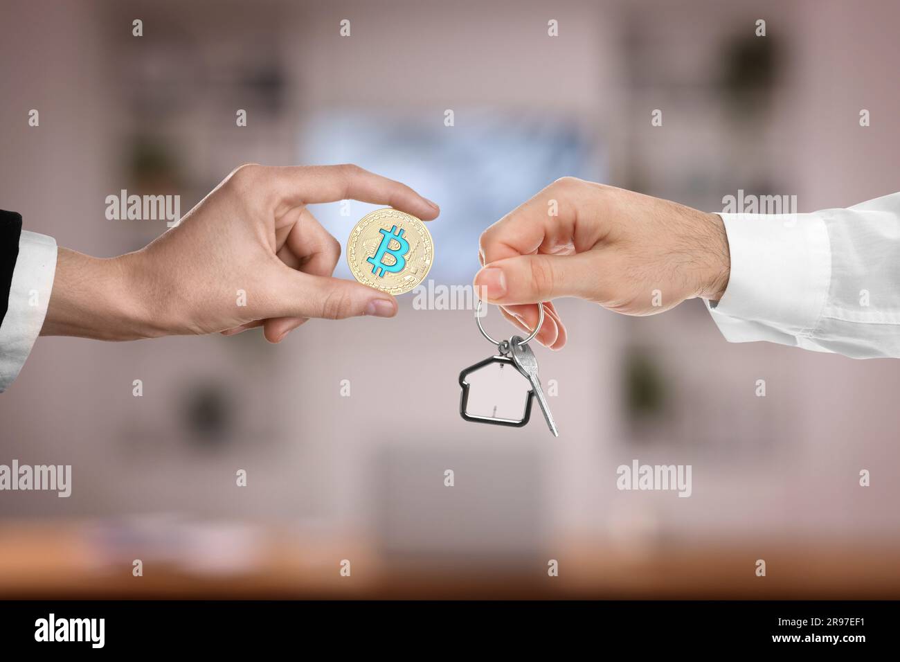 Bitcoin exchange. Man using cryptocurrency to buy house. Seller holding key  and buyer with bitcoin indoors, closeup Stock Photo - Alamy