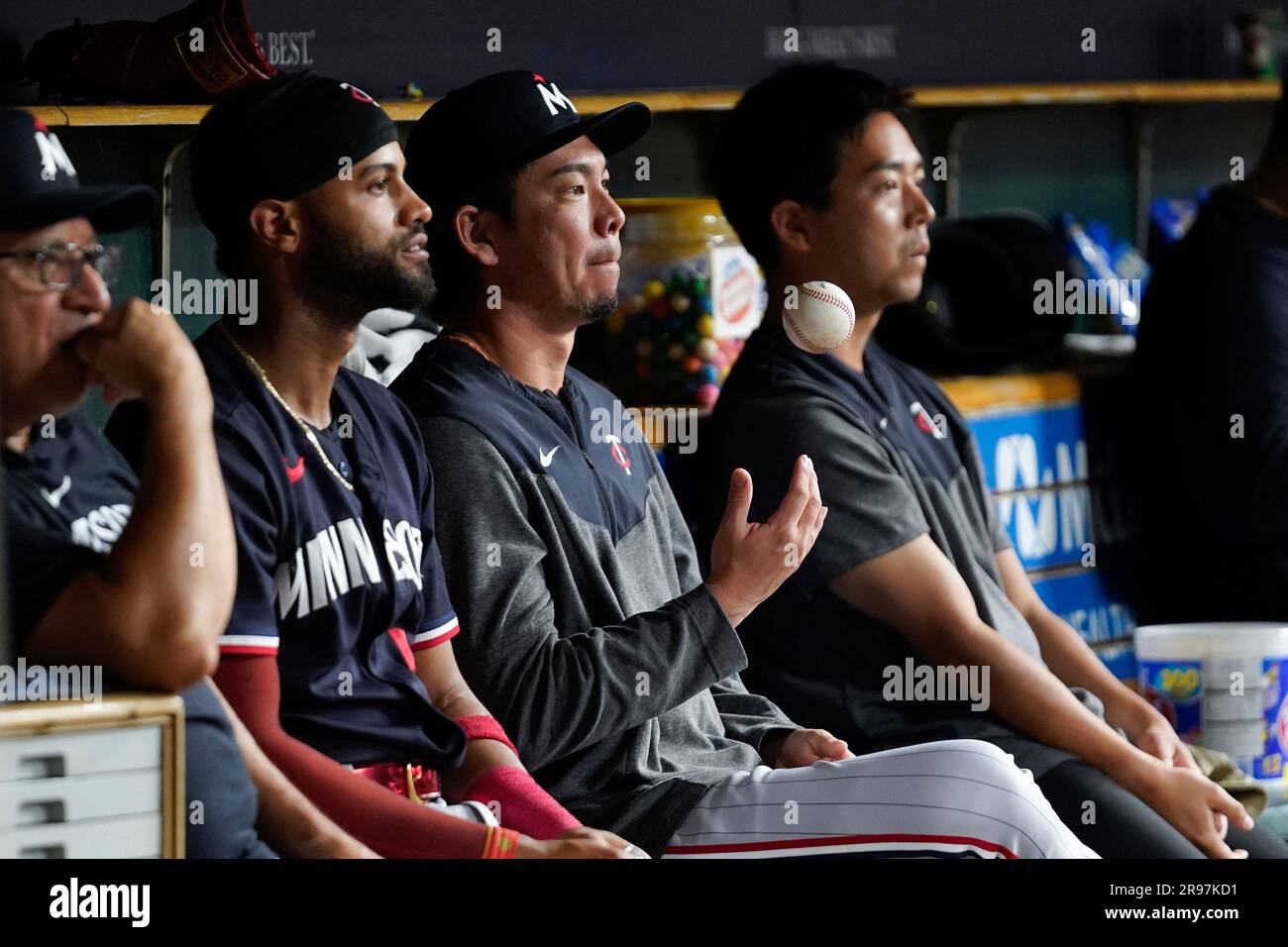 Minnesota Twins pitcher Kenta Maeda tosses a ball in the dugout in the