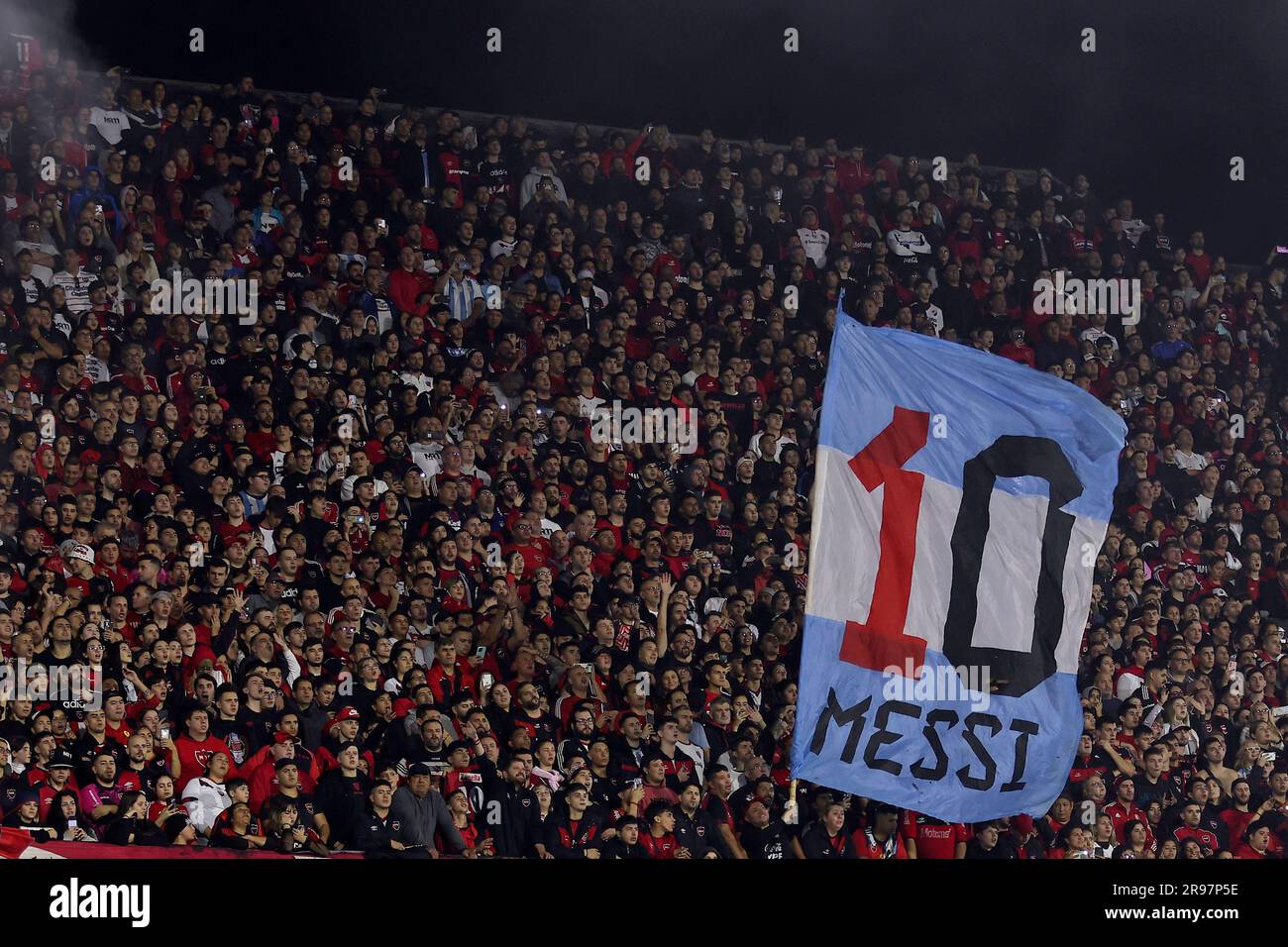 A soccer fan holds an Argentina flag with the number 10, referring to