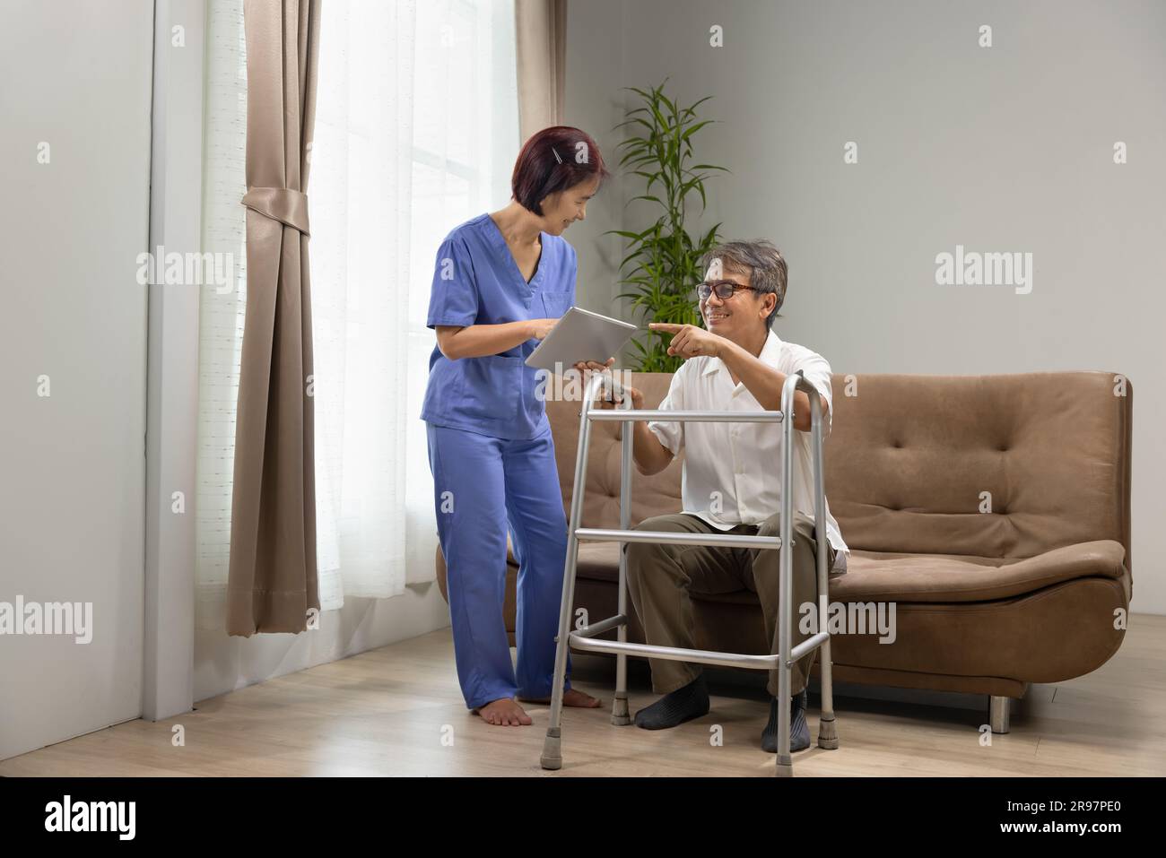 Caregiver take care older man that having Sarcopenia and muscle loss. Sarcopenia is a degenerative disease of the muscle usually caused by the natural Stock Photo
