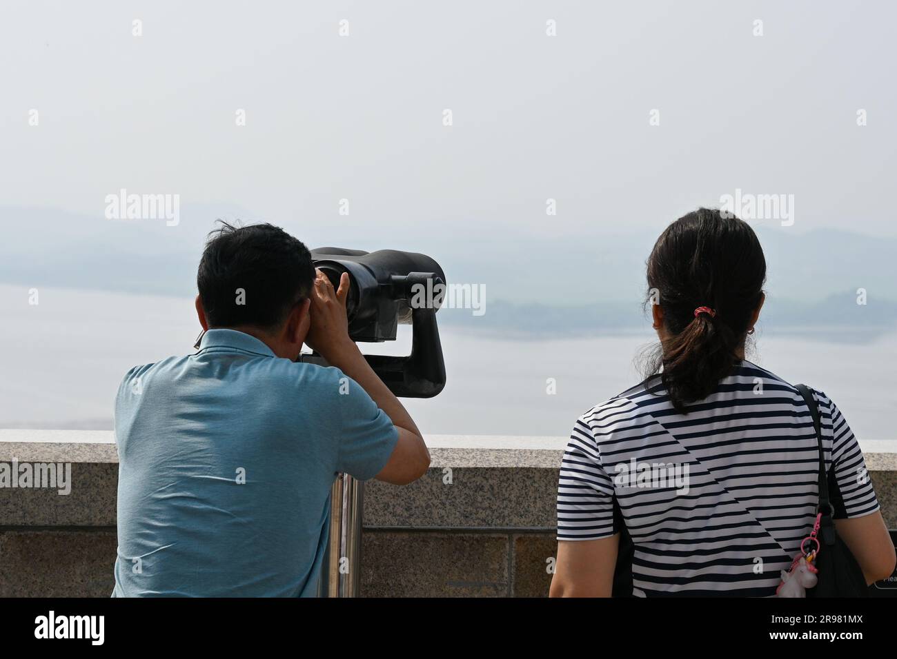 Paju, South Korea. 24th June, 2023. Visitors look through binoculars toward North Korea at Odusan Unification Observatory near Paju, South Korea, on Saturday, June 24, 2023. The Korean War broke out on June 25, 1950 and lasted for three years before fighting ended with an armistice. Photo by Thomas Maresca/UPI Credit: UPI/Alamy Live News Stock Photo