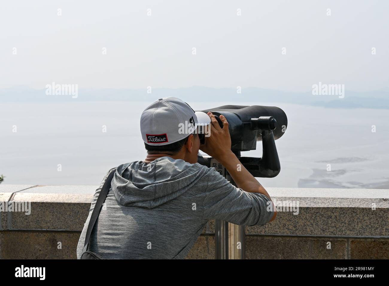 Paju, South Korea. 24th June, 2023. A visitor looks through binoculars toward North Korea at Odusan Unification Observatory near Paju, South Korea, on Saturday, June 24, 2023. The Korean War broke out on June 25, 1950 and lasted for three years before fighting ended with an armistice. Photo by Thomas Maresca/UPI Credit: UPI/Alamy Live News Stock Photo