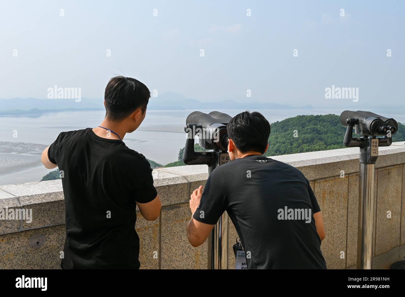 Paju, South Korea. 24th June, 2023. Visitors look through binoculars toward North Korea at Odusan Unification Observatory near Paju, South Korea, on Saturday, June 24, 2023. The Korean War broke out on June 25, 1950 and lasted for three years before fighting ended with an armistice. Photo by Thomas Maresca/UPI Credit: UPI/Alamy Live News Stock Photo