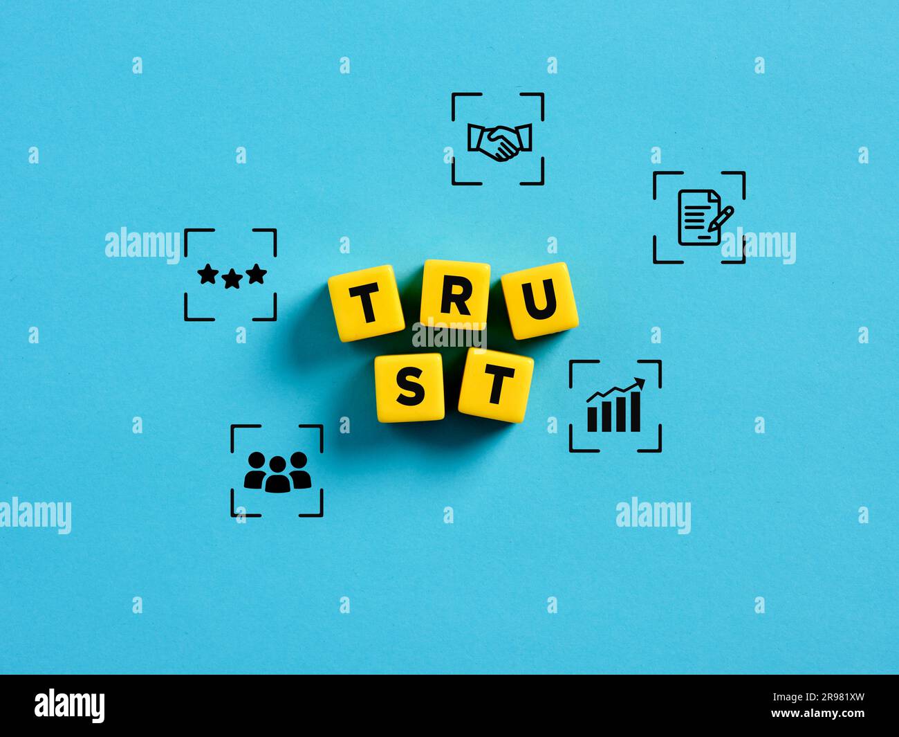 Trust, partnership and business. Organizational trust. The word trust on yellow cubes with business symbols. Stock Photo