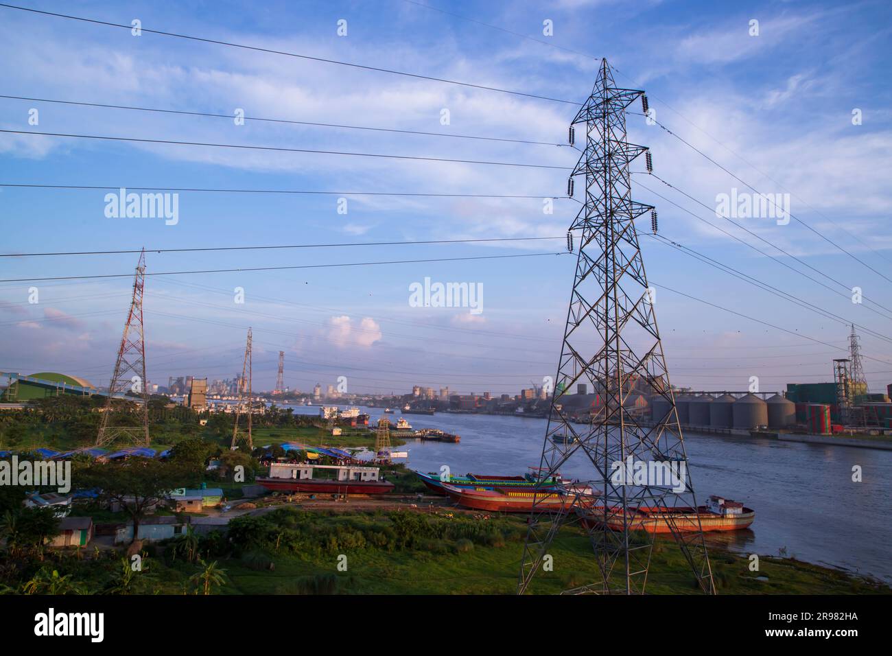Aerial view of High voltage power line on the river and blue sky