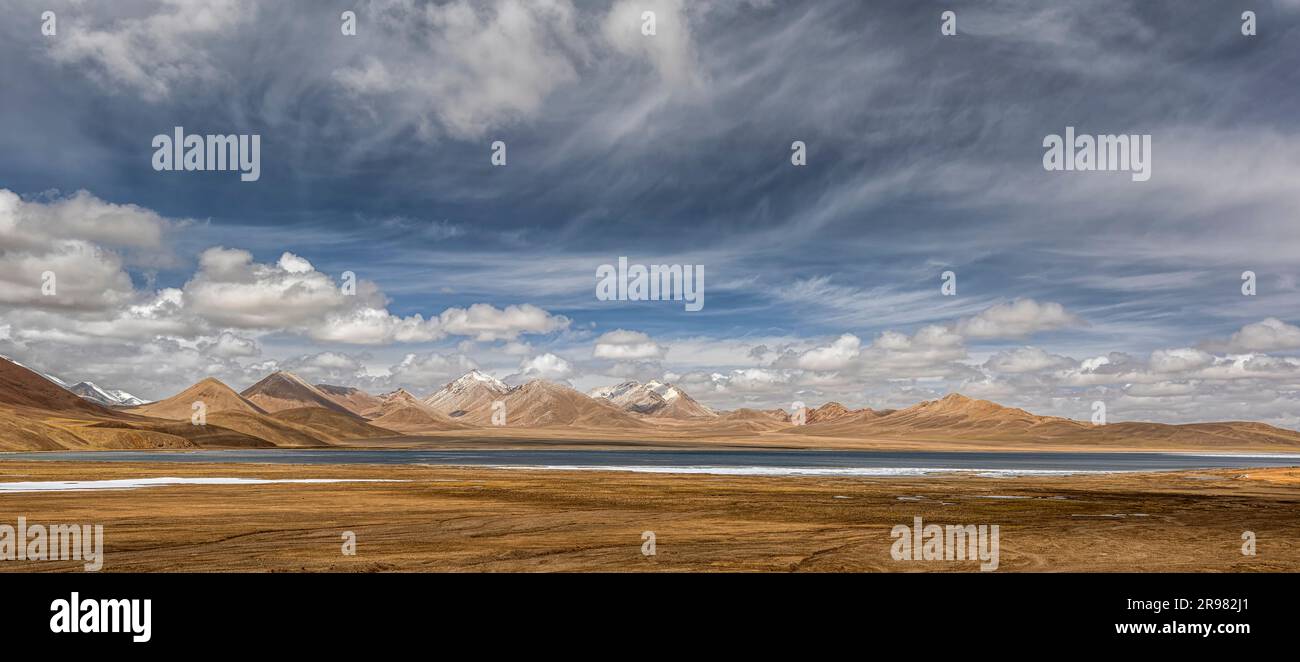 The stunning landscape in the Ali region of Tibet, with majestic mountains and a tranquil blue lake Stock Photo