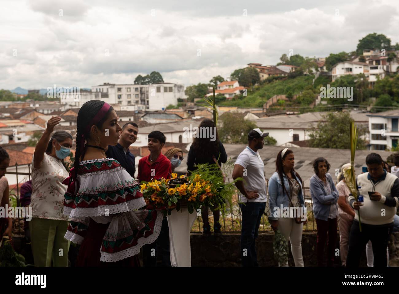 A group of people dressed in traditional attire participating in a religious procession on Domingo de Ramos in the city of Popayan, Colombia Stock Photo