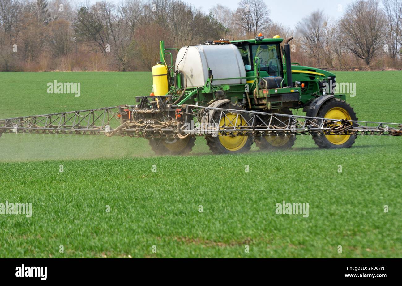 Chortkiv - Ternopil - Ukraine - April 22, 2021. Treatment of wheat crops with insecticides for protection against pests in the farm 'Yagelniski'. Stock Photo