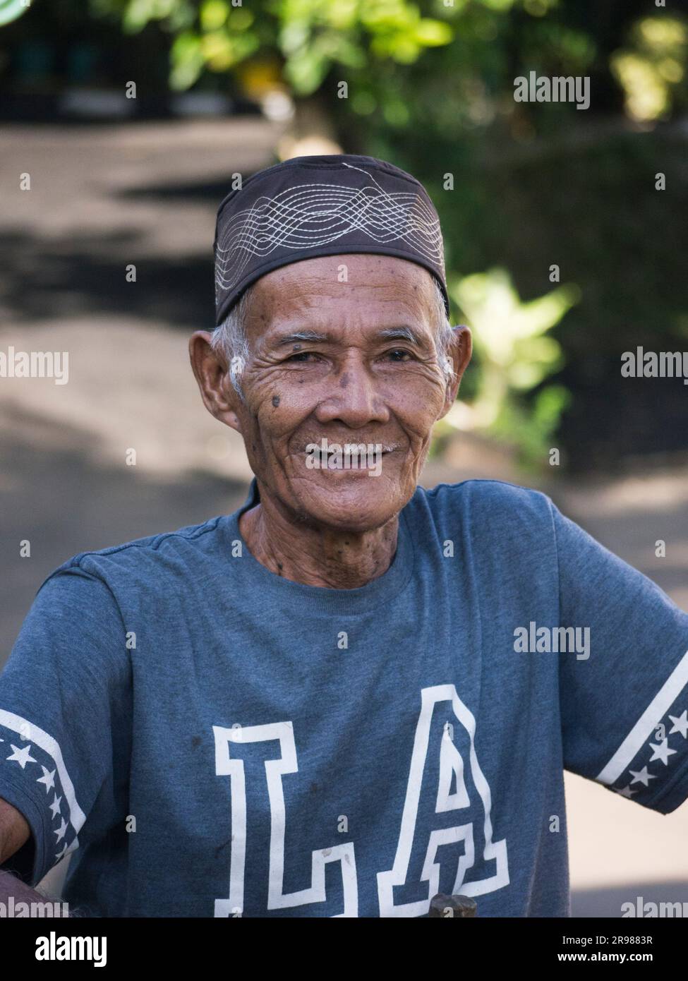 Jakarta, Indonesia - June 20, 2023 : portrait of asian senior man wearing black skullcap with gray hair smiling facing camera Stock Photo