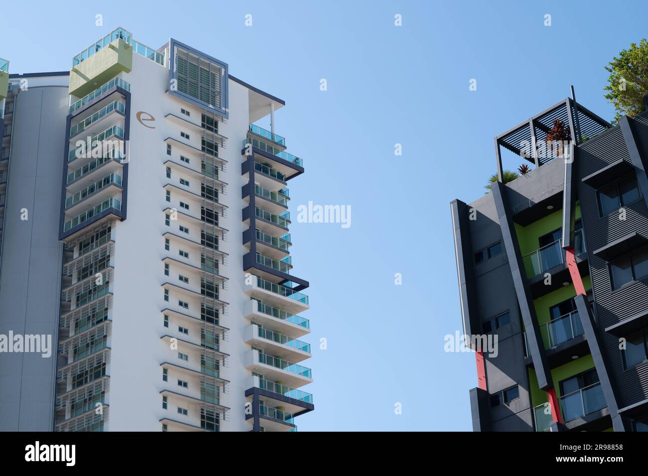 A photograph of two high-rise buildings emphasizing different exterior decoration design, and the air space between them. Stock Photo
