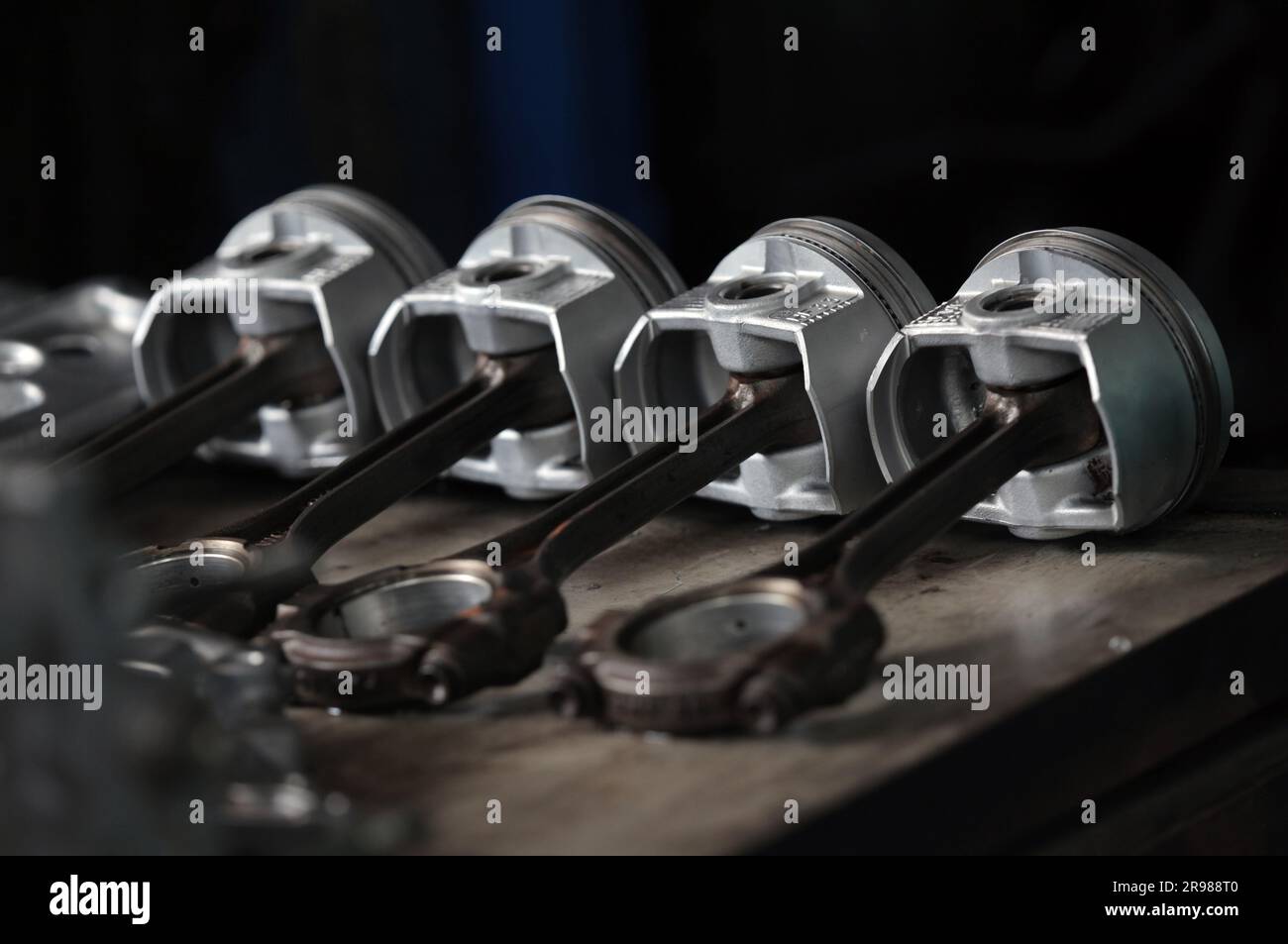 several car pistons lined up on the table Stock Photo