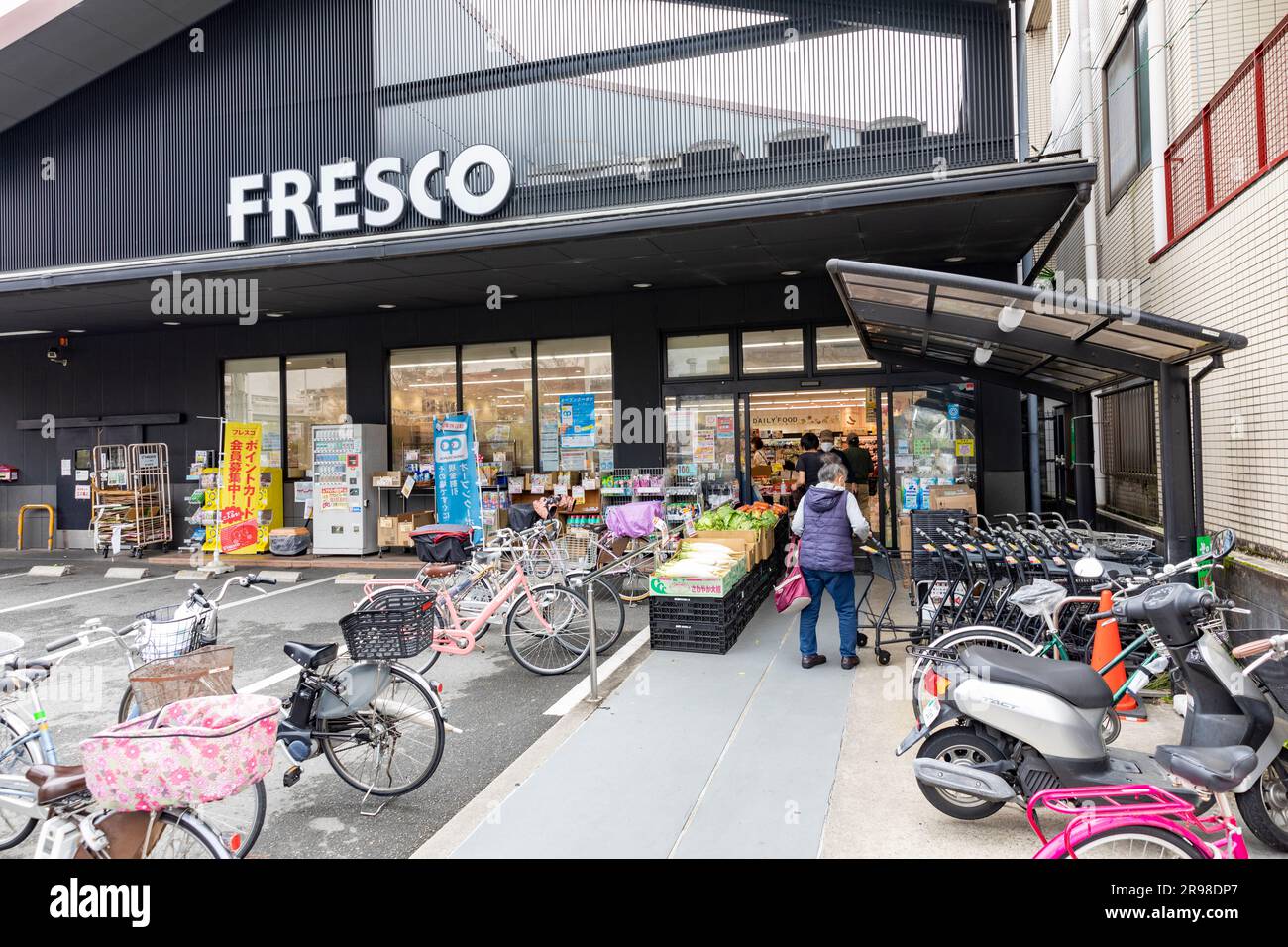 Fresco supermarket store in Kyoto, Japan, bicycles and scooters parked