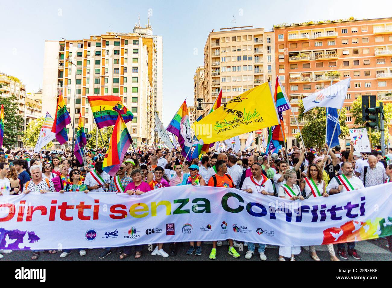 A vibrant crowd of people in the streets of Milan celebrating the annual Milano Pride parade