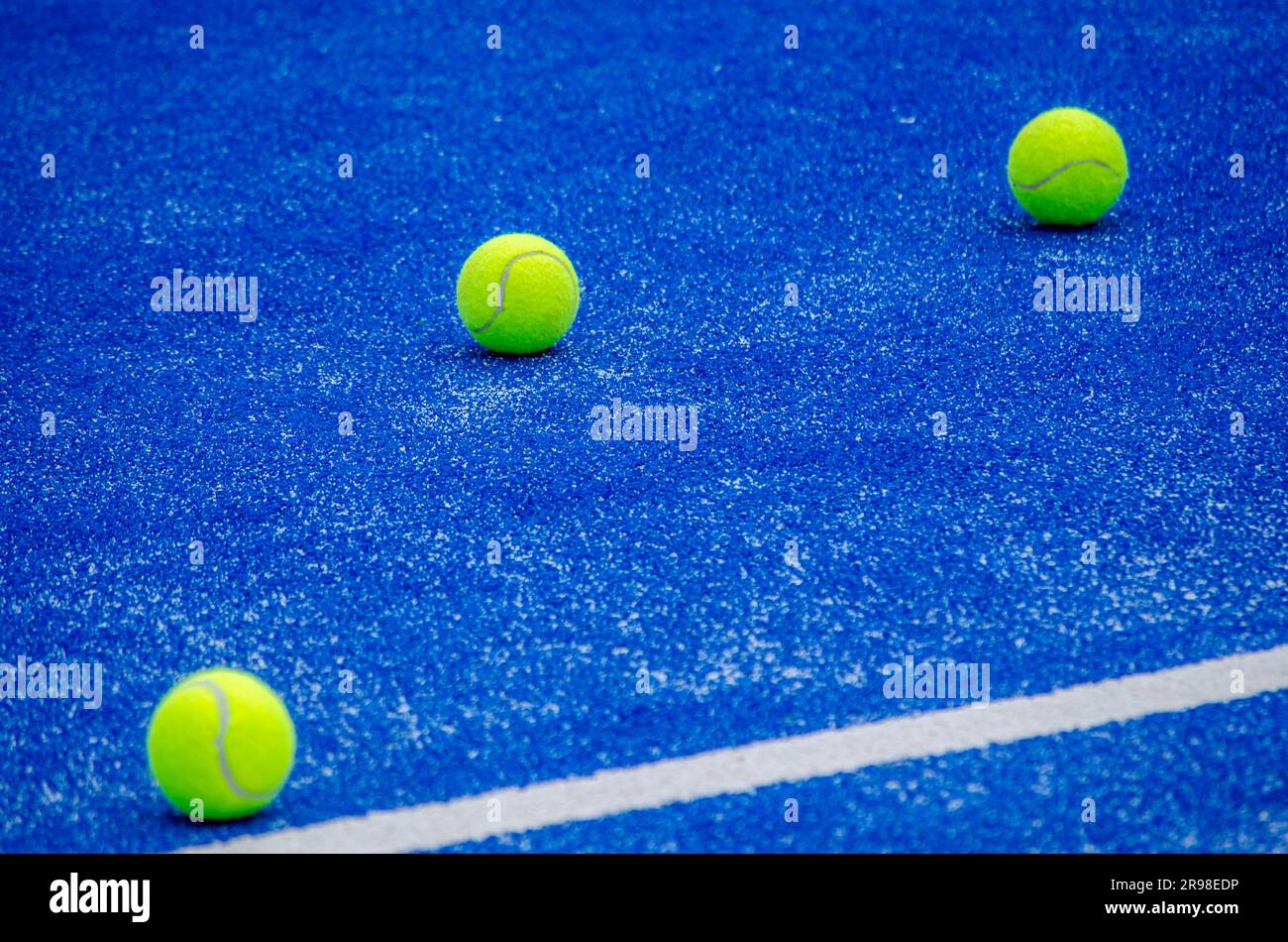 three balls on a paddle tennis court Stock Photo Alamy