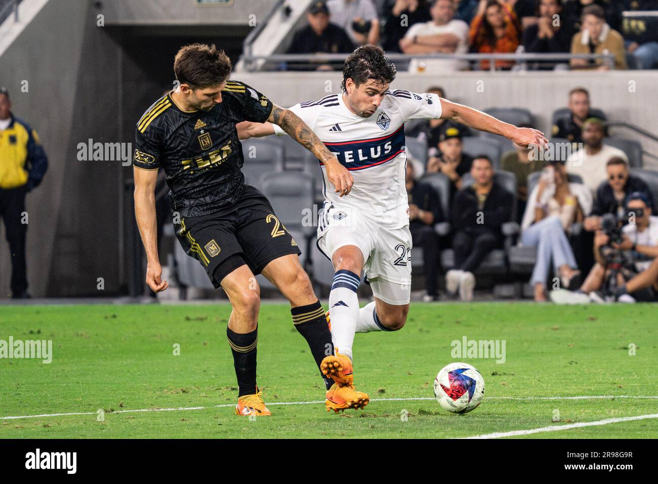 Vancouver Whitecaps forward Brian White (24) is defended by LAFC midfielder Ryan Hollingshead (24) during a MLS match, Saturday, June 24, 2023, at the Stock Photo