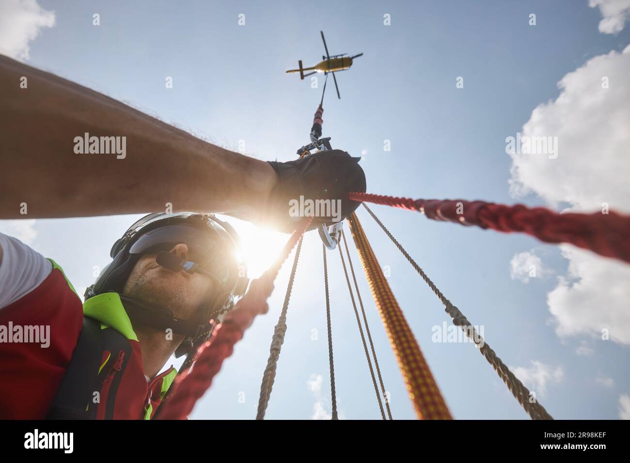 Trutnov, Czech Republic - June 22, 2023: Training of rescue in difficult to access terrain. Doctor of Helicopter Emergency Medical Service hanging on Stock Photo