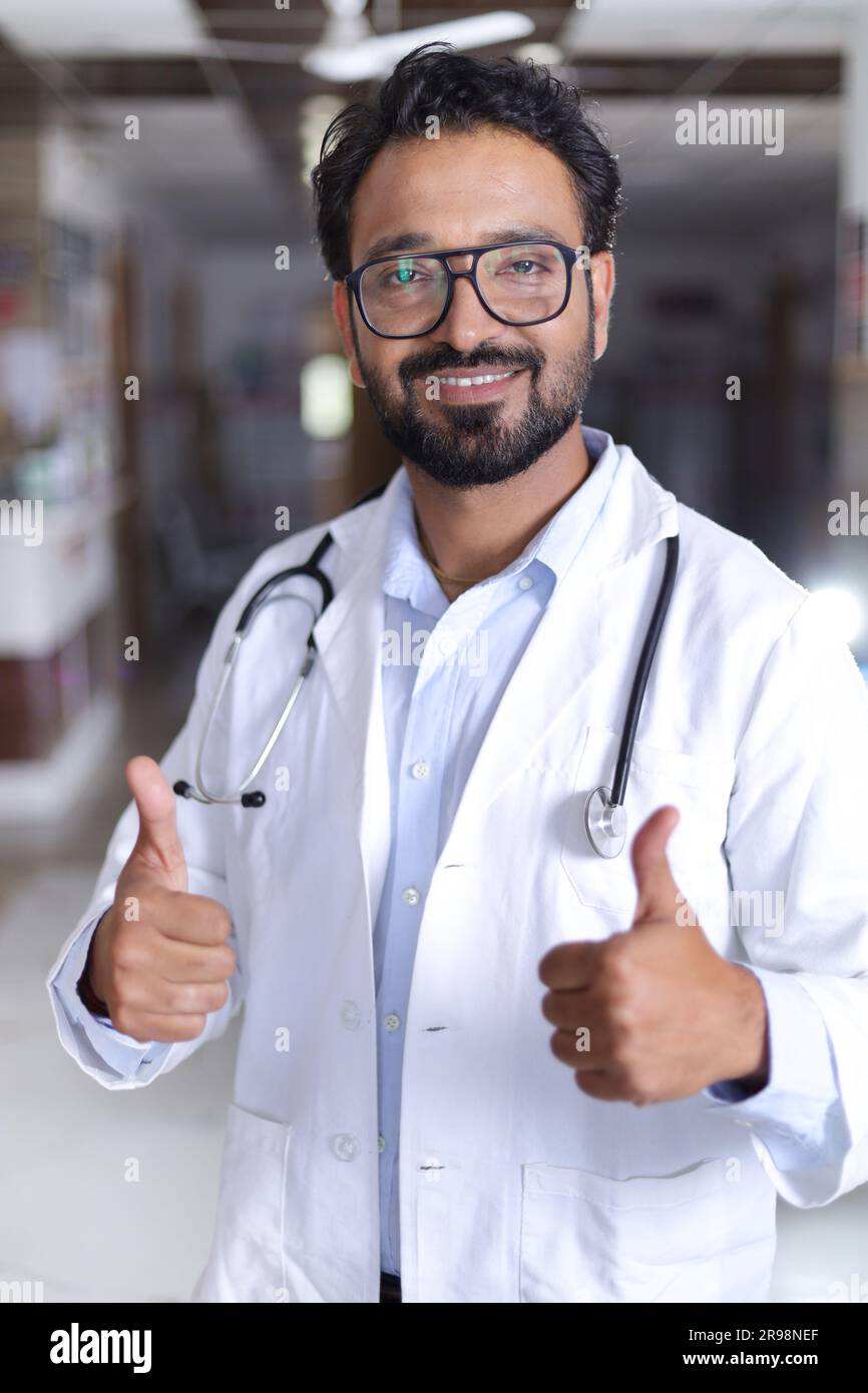 Happy Indian senior Medical professional standing portrait in hallway
