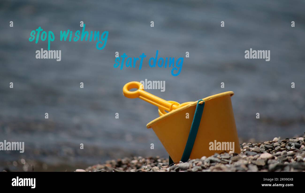 Stop wishing, start doing sentence. Toy bucket shovel on the beach