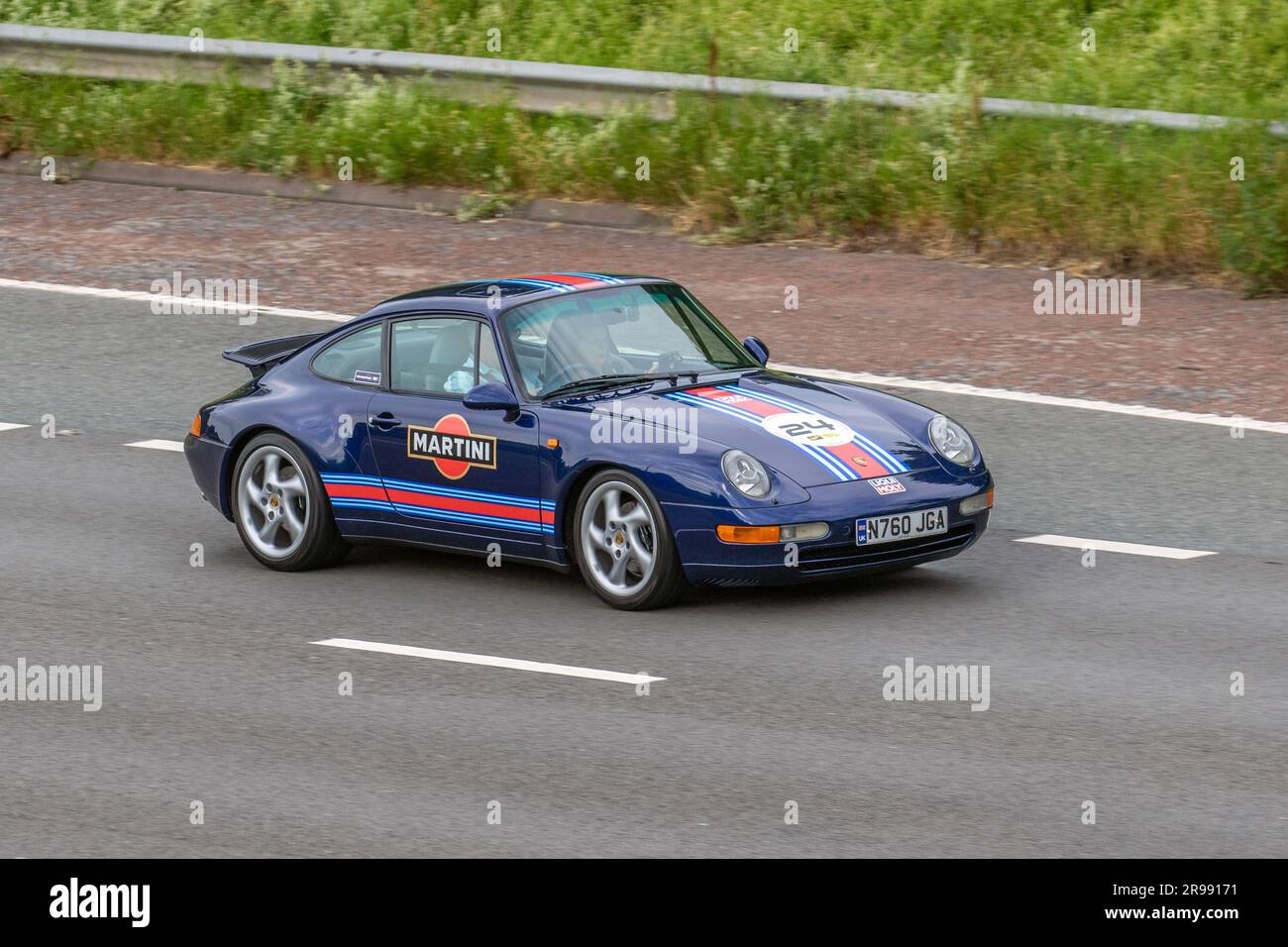 Car No.24 1995 90s nineties Blue Martini Porsche 911 Carrera, Coupe 3600 cc, travelling at speed on the M6 motorway in Greater Manchester, UK Stock Photo