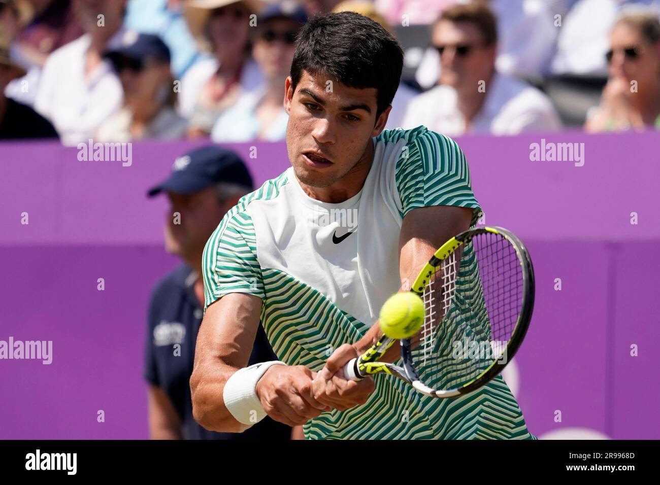 Carlos Alcaraz, of Spain, returns with a backhand to Alex de Minaur, of Australia, during their mens singles final match at the Queens Club tennis tournament in London, Sunday, June 25, 2023