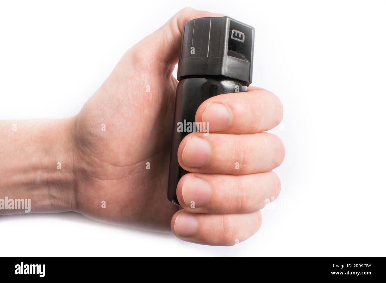Hand with bottle of pepper spray in eyes, isolated on white background