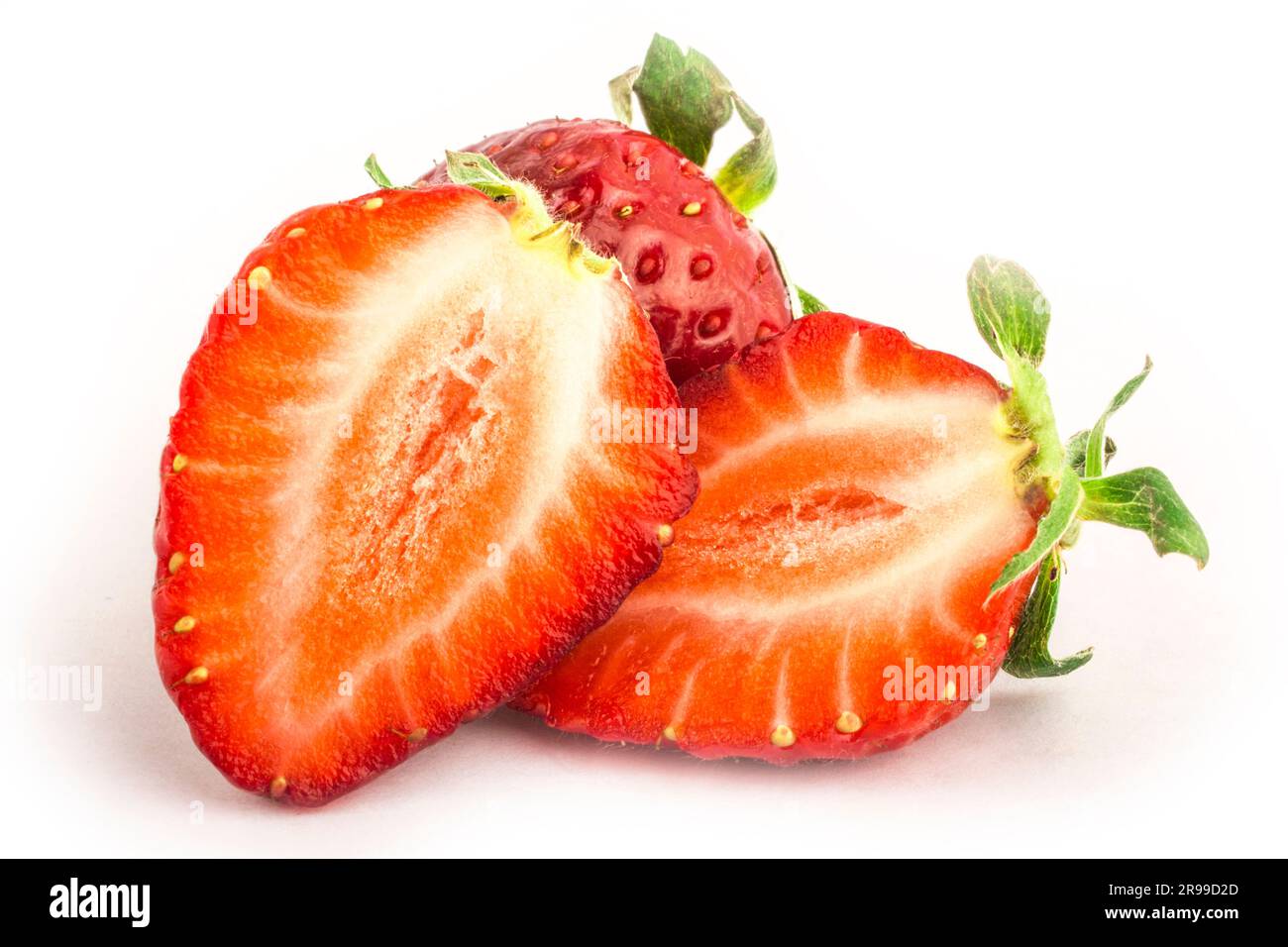 Isolated red strawberries. Three fruits, one cut in half on a white background Stock Photo Alamy