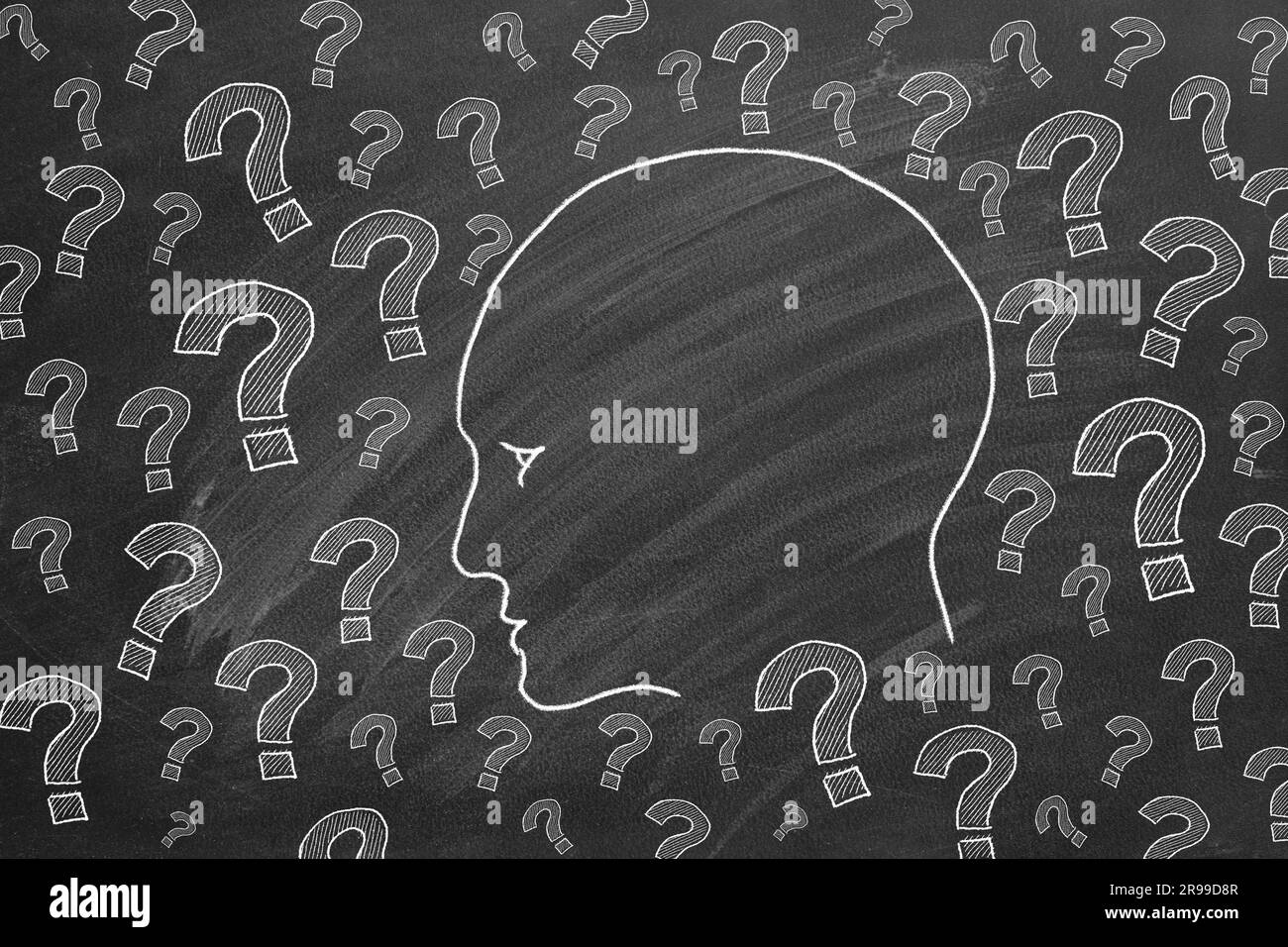 Human head with question marks. Illustration on blackboard. Stock Photo
