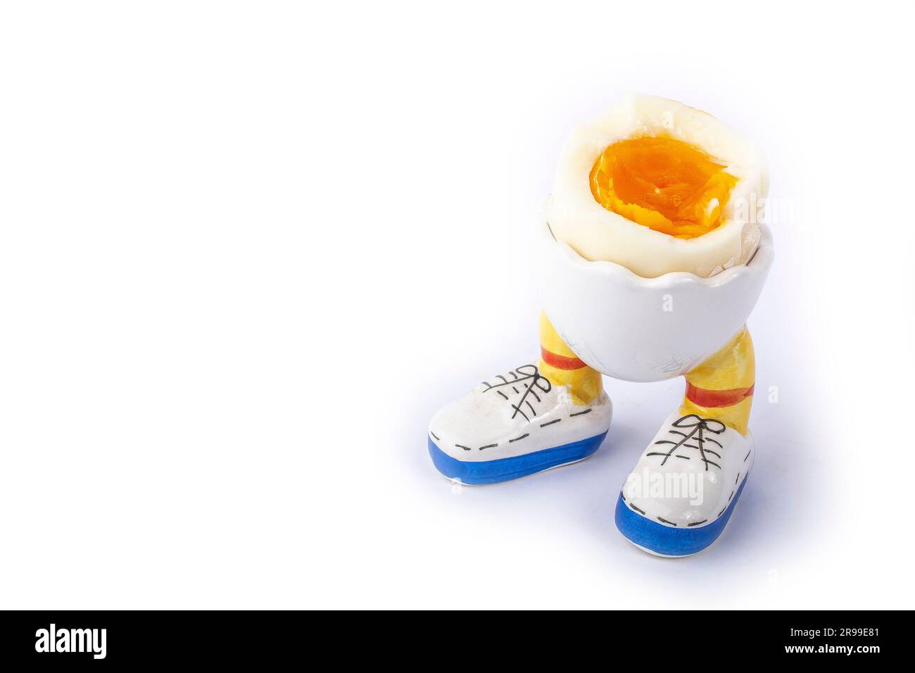 boiled egg open half in stand in the form of legs isolate Stock Photo
