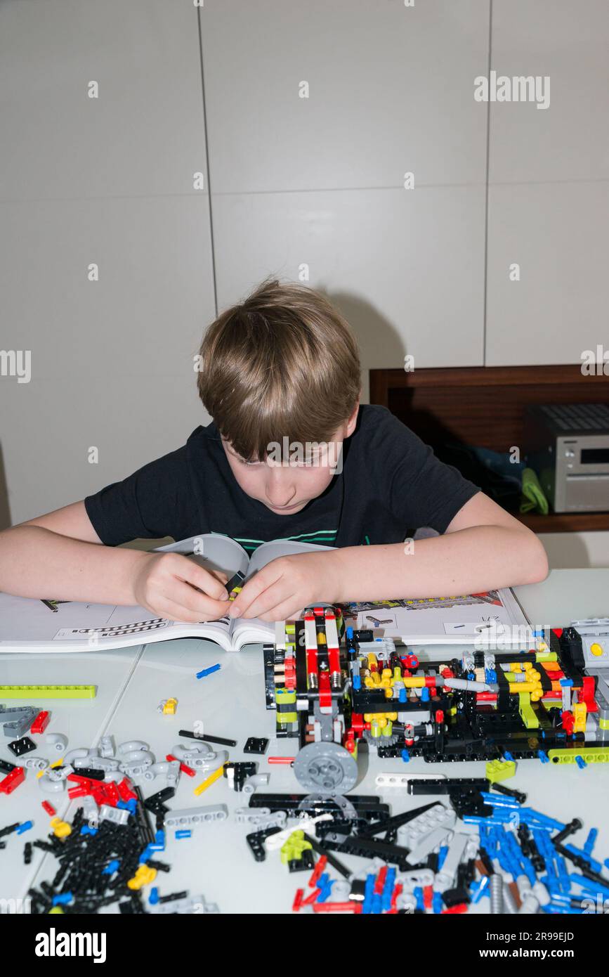9 year old boy playing with Lego set Stock Photo Alamy