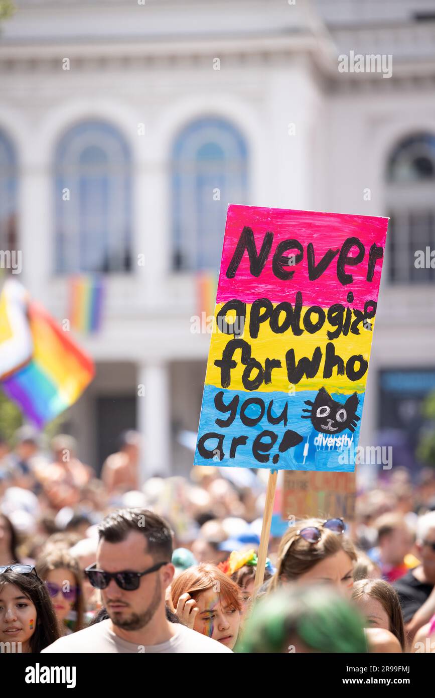 Munich, GERMANY - June 24, 2023: People at the Parade at Christopher Street  Day CSD in Munich. Poster with the text 'Never apologize for who you are! Stock Photo