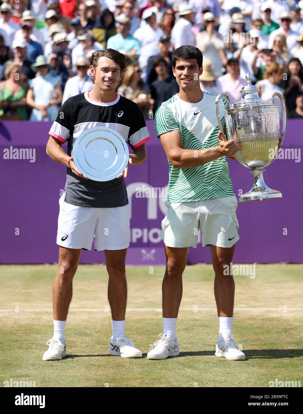 Runner-up Alex de Minaur and winner Carlos Alcaraz pose with their trophies following the mens singles final on day seven of the 2023 cinch Championships at The Queens Club, London