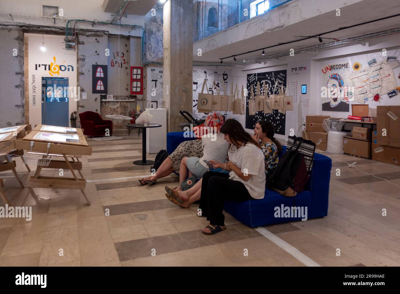 Israeli religious students sit in the exhibition space which show their work during end of year graduates exhibition of the Visual Communications department of Emuna - Efrata, Academic College of Art and Education in Jerusalem Israel Stock Photo