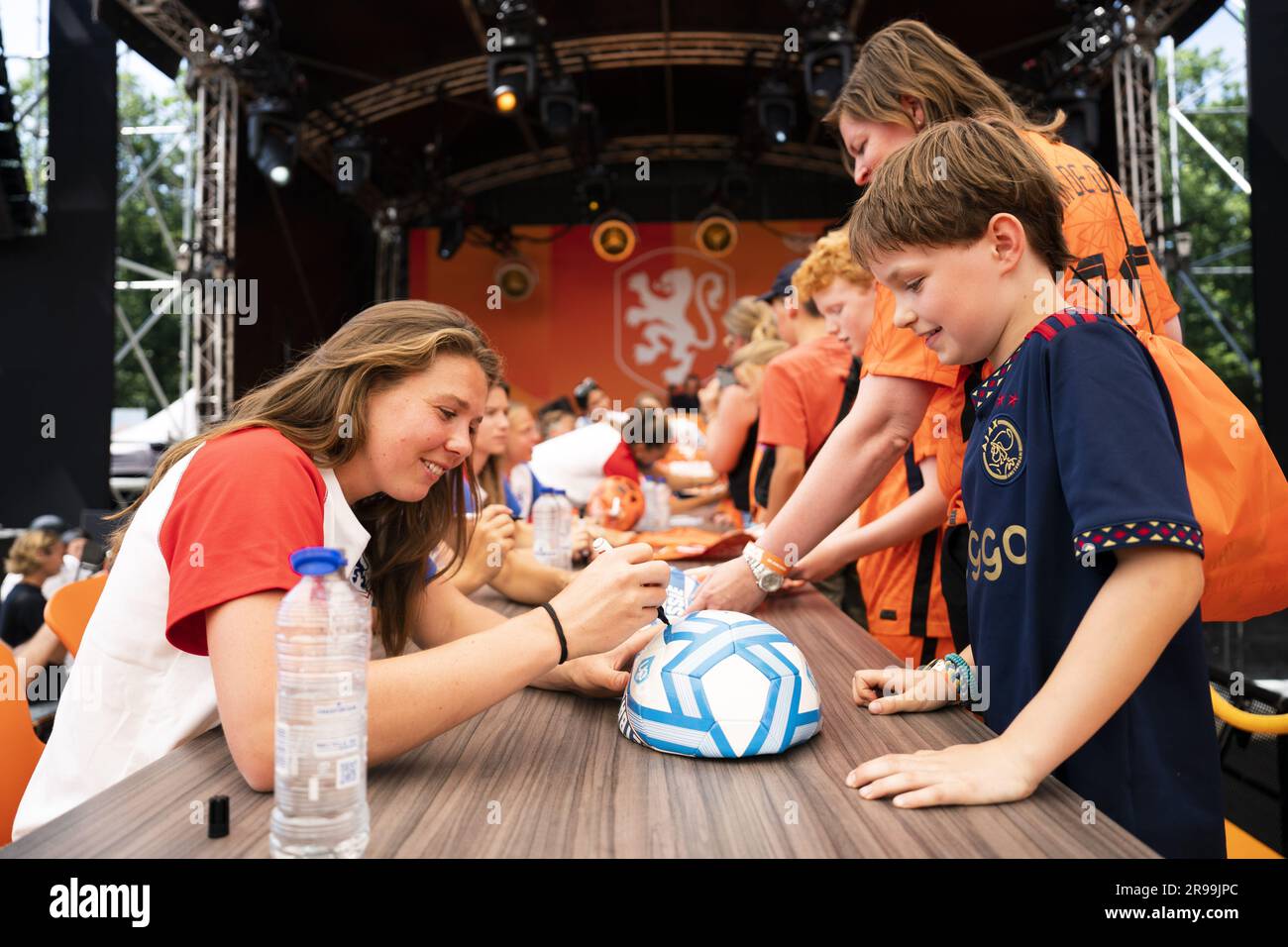 ZEIST Fans collect signatures from the Orange Women during the Orange