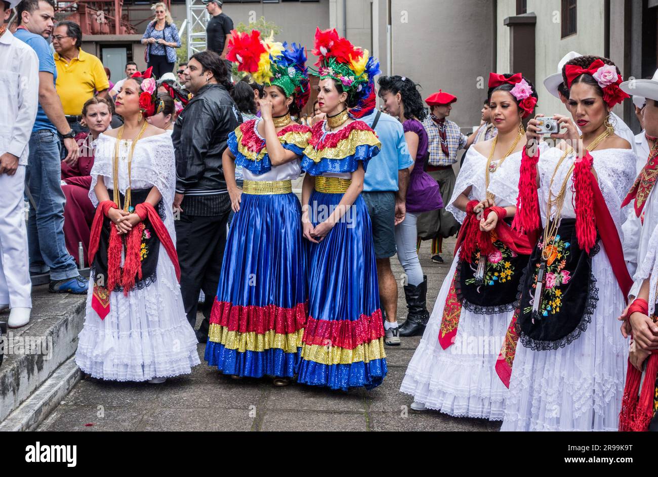 Young women dressed in colorful traditional dress are waiting to ...