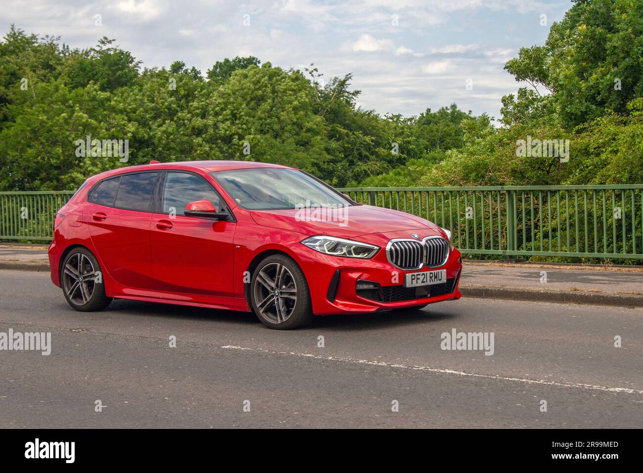 2021 Red BMW 118I M Sport Auto 118I 1.5 136 DCT Steptronic Auto Start/Stop Car Hatchback Petrol 1499 cc; crossing motorway bridge in Greater Manchester, UK Stock Photo
