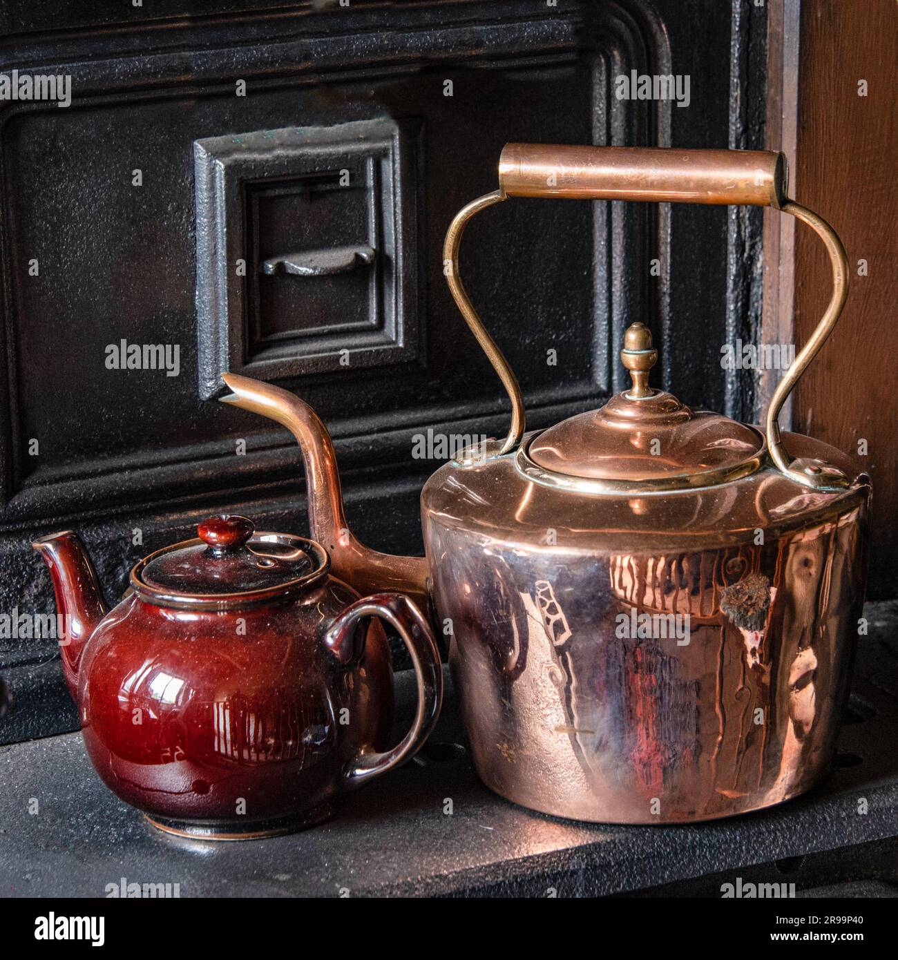 Vintage kettle and teapot on an old cooking range Stock Photo