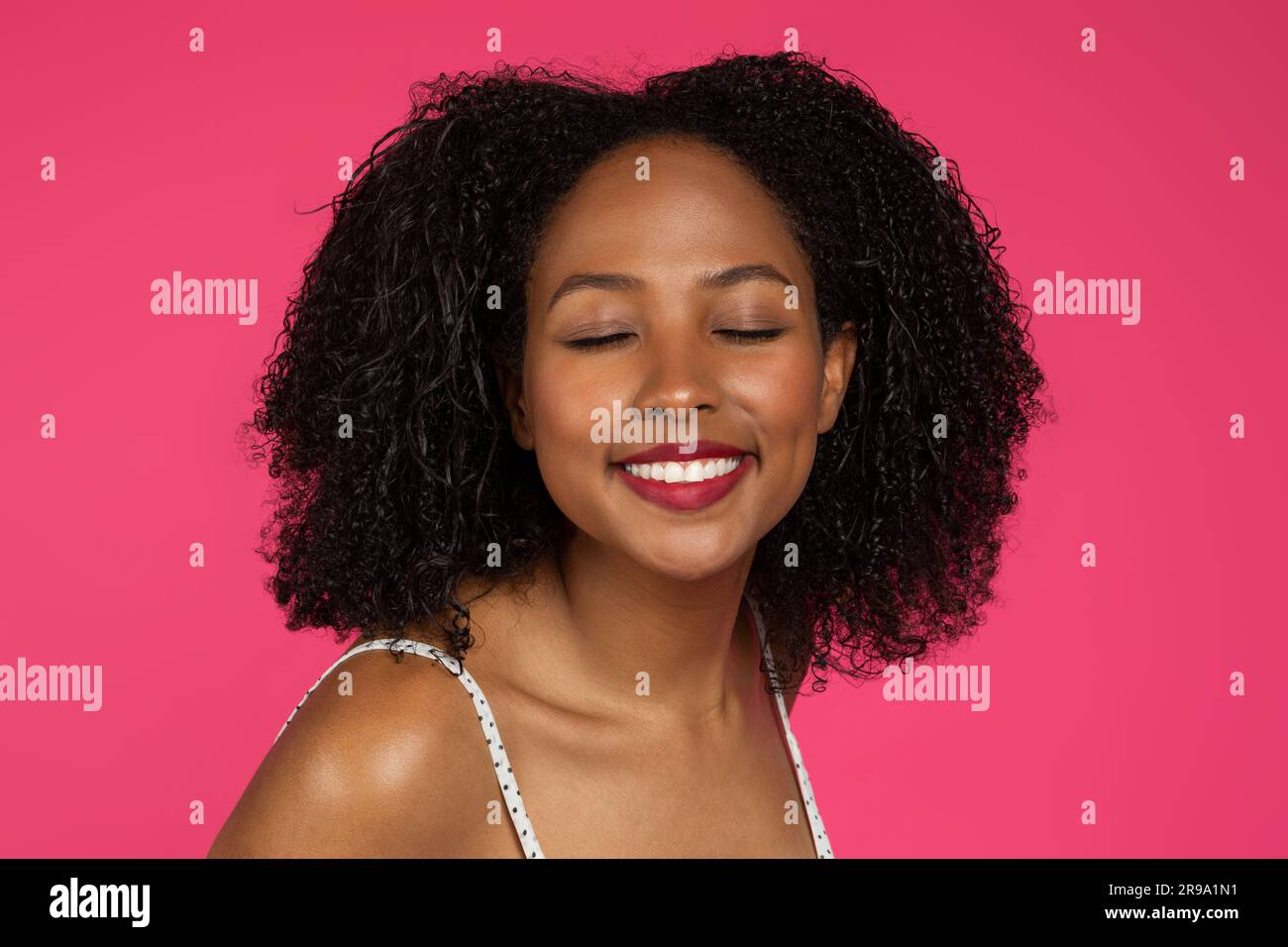Smiling satisfied millennial black woman student with closed eyes, enjoy free time Stock Photo