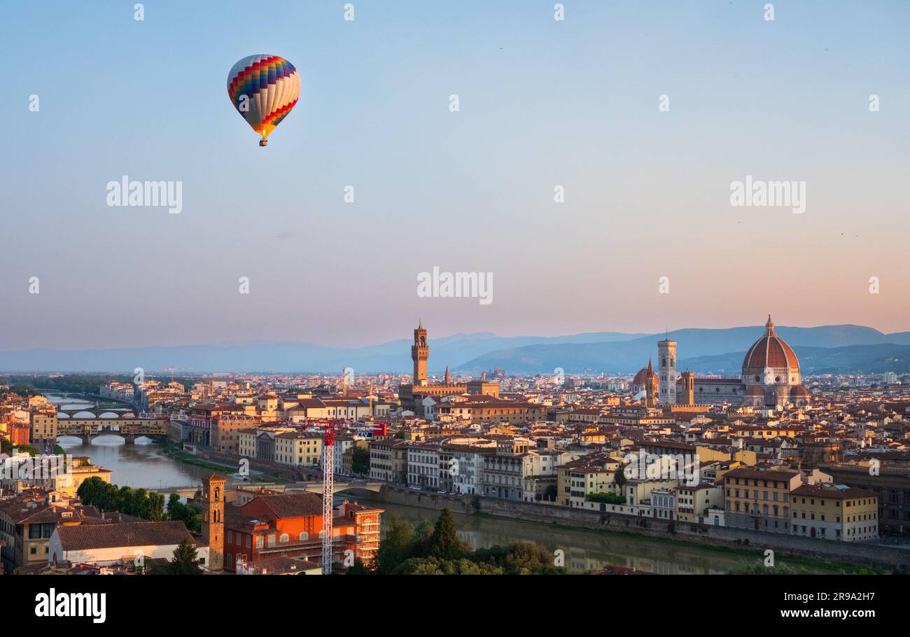 Hot air balloon rising in front of the Duomo in Florence during sunrise