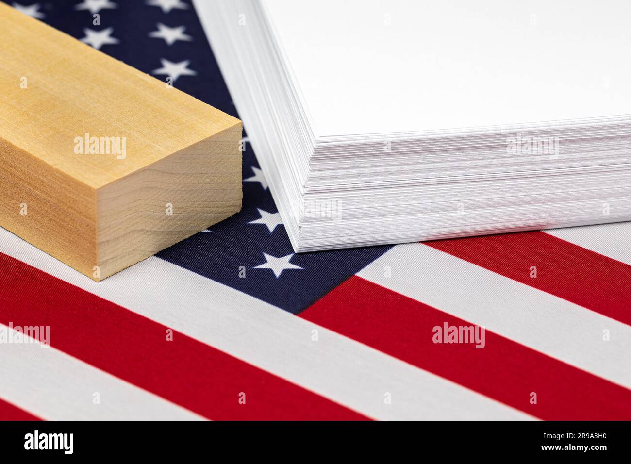 Ream of printer paper, wood and United States of America flag. Paper products industry, trade and manufacturing concept Stock Photo