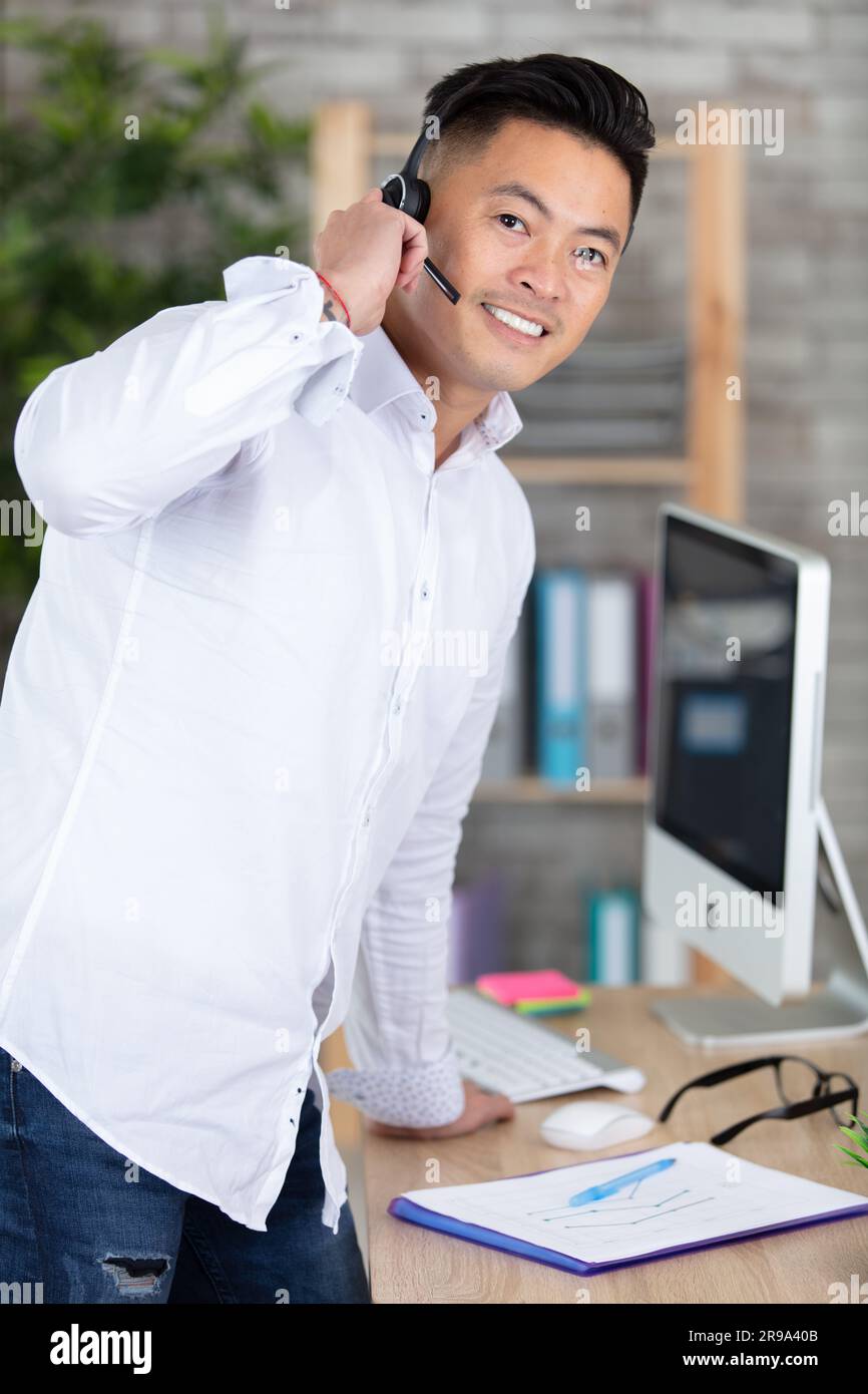 young smiling male call centre operator Stock Photo