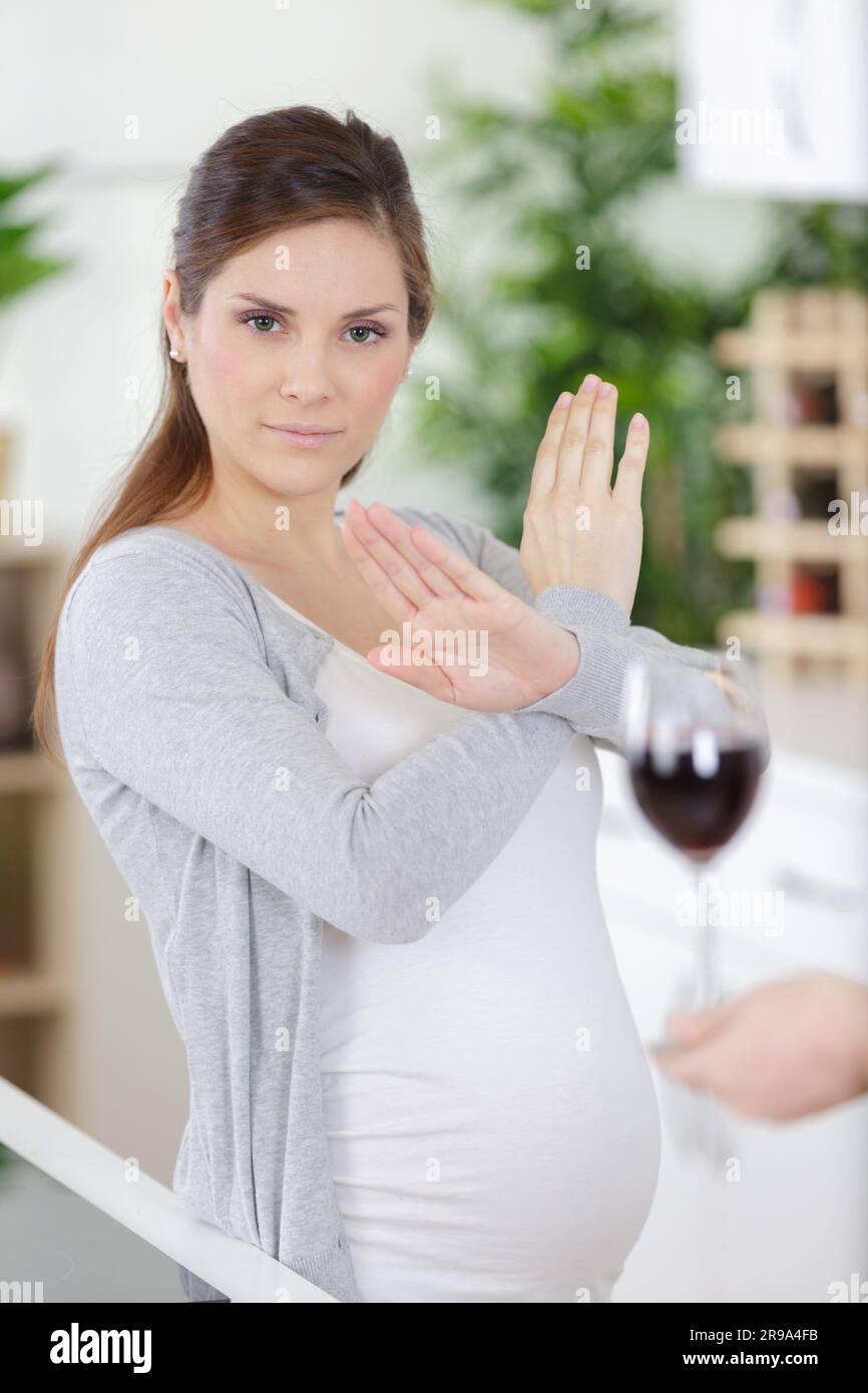 pregnant woman refusing wine with an arm gesture Stock Photo Alamy
