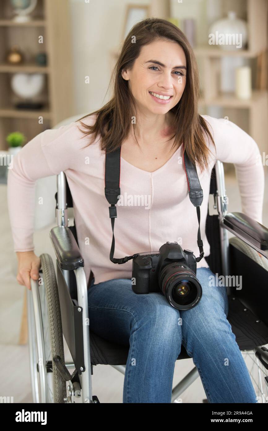 happy female photographer on wheelchair Stock Photo